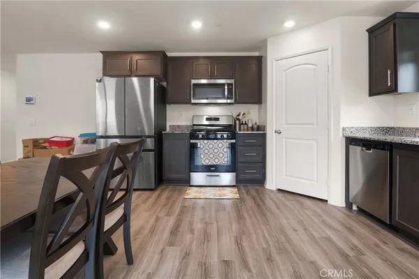 a kitchen with stainless steel appliances a refrigerator stove microwave and cabinets