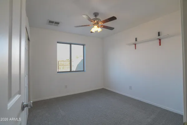 a view of a livingroom with a ceiling fan and window