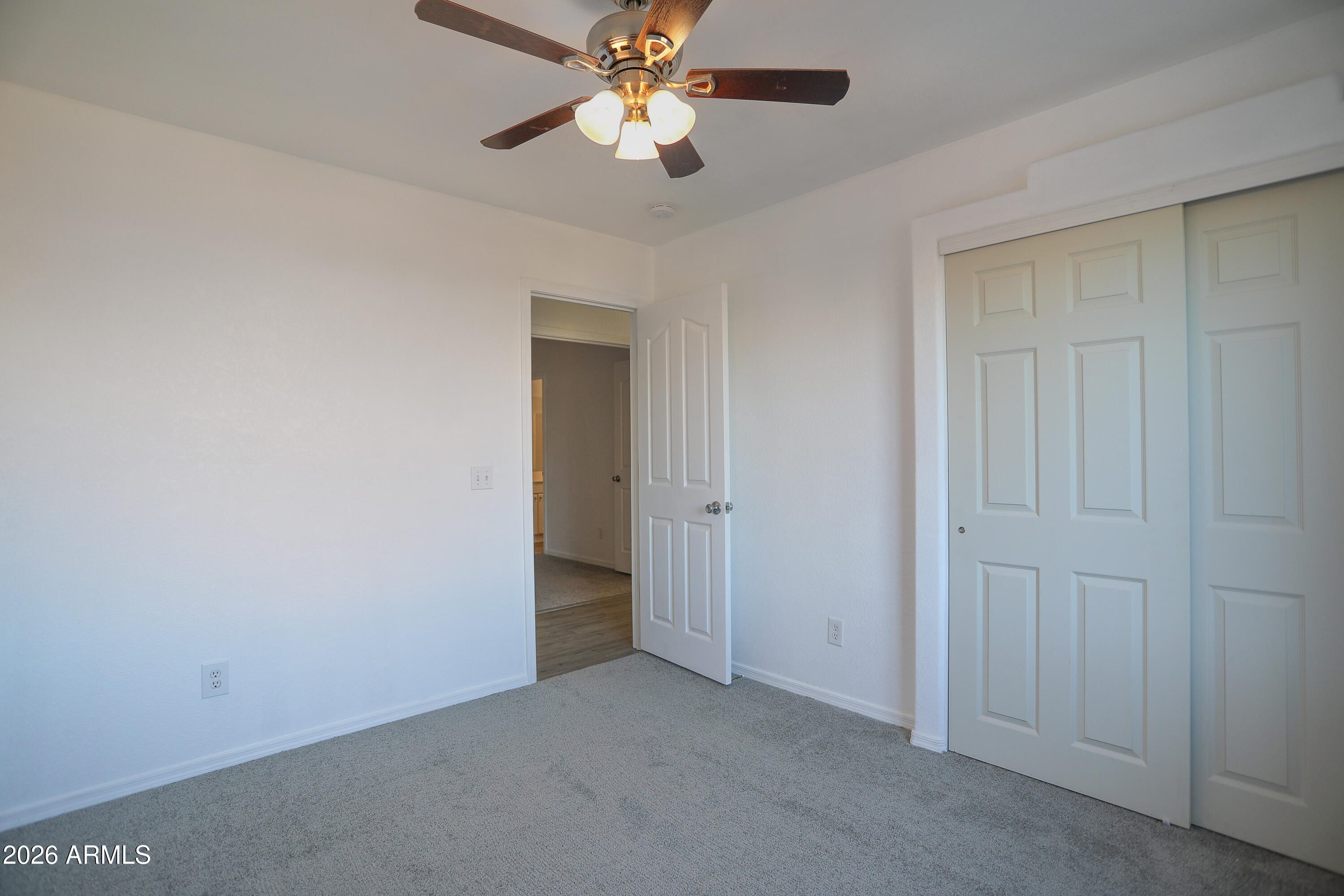 762 West 17th Avenue Apache Junction, AZ 85120 - Photo 12 of 19 an empty room with closet and a chandelier fan