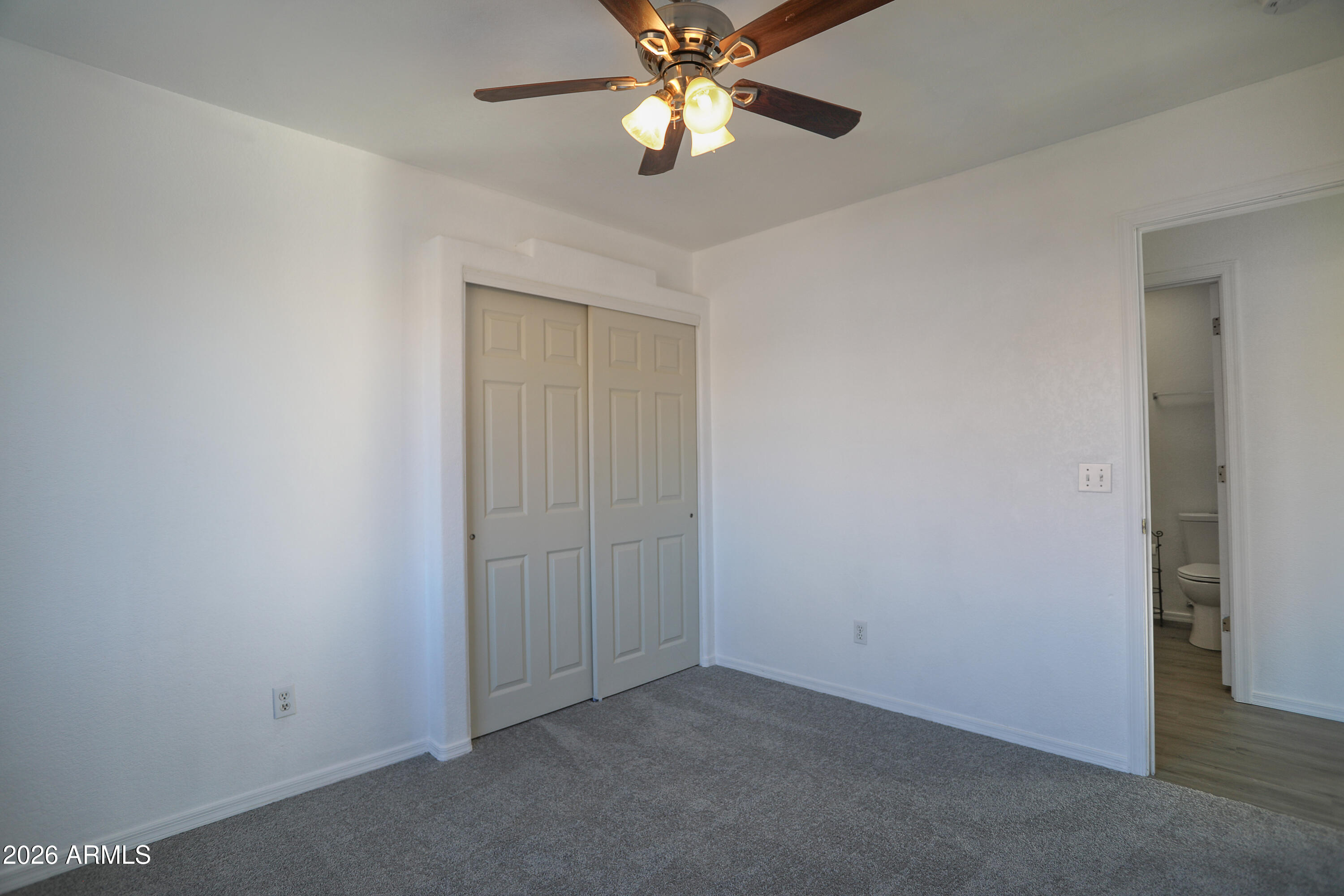762 West 17th Avenue Apache Junction, AZ 85120 - Photo 14 of 19 an empty room with closet and a chandelier fan