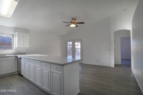 a kitchen with a sink cabinets and wooden floor