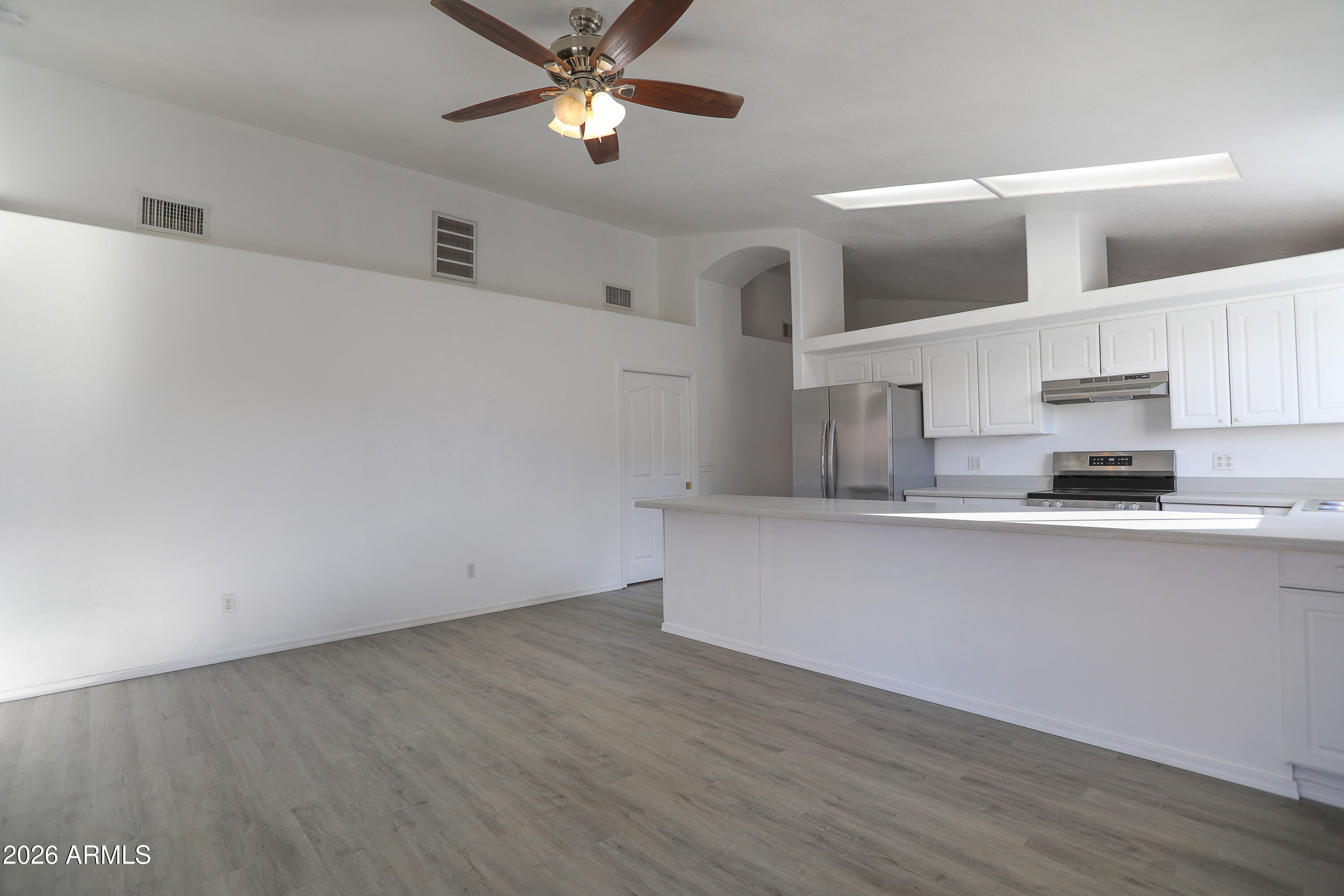 762 West 17th Avenue Apache Junction, AZ 85120 - Photo 6 of 19 a kitchen with stainless steel appliances a wooden floor and window