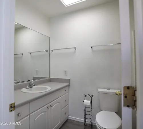a bathroom with a sink toilet and a mirror
