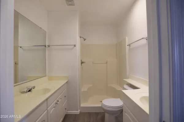 a bathroom with a granite countertop sink toilet and shower