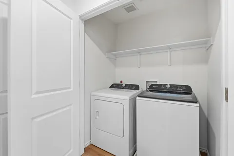 a view of storage and utility room with washer and dryer