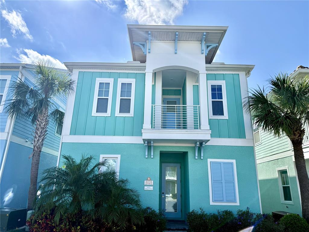 a front view of a house with plants