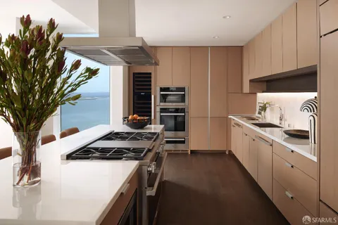 a view of a kitchen with a table and chairs