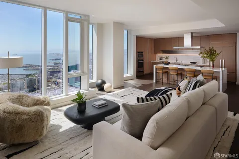 a living room with furniture a bookshelf and a window