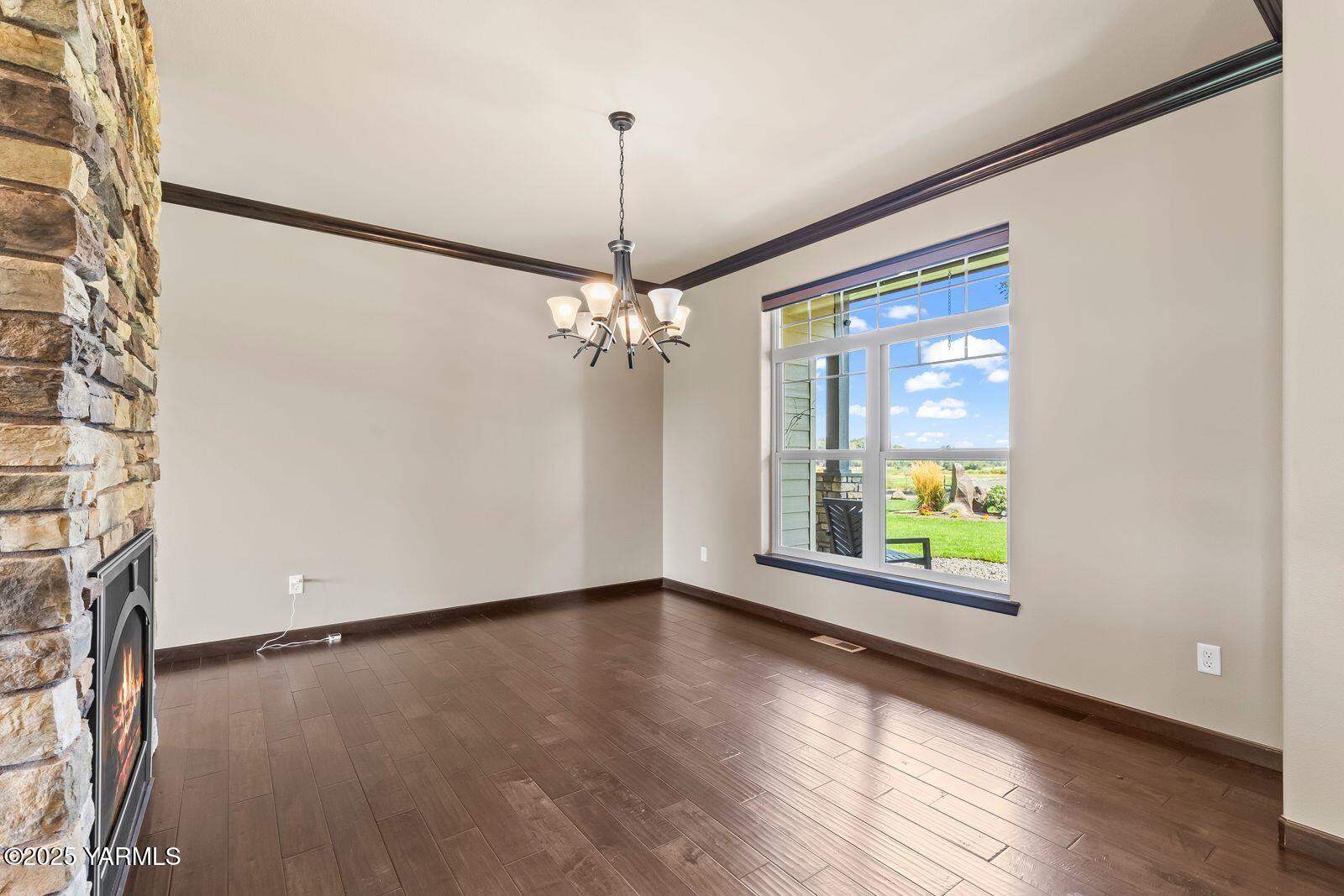 1209 Dazet Road Yakima, WA 98908 - Photo 15 of 63 a view of an empty room with a window and wooden floor