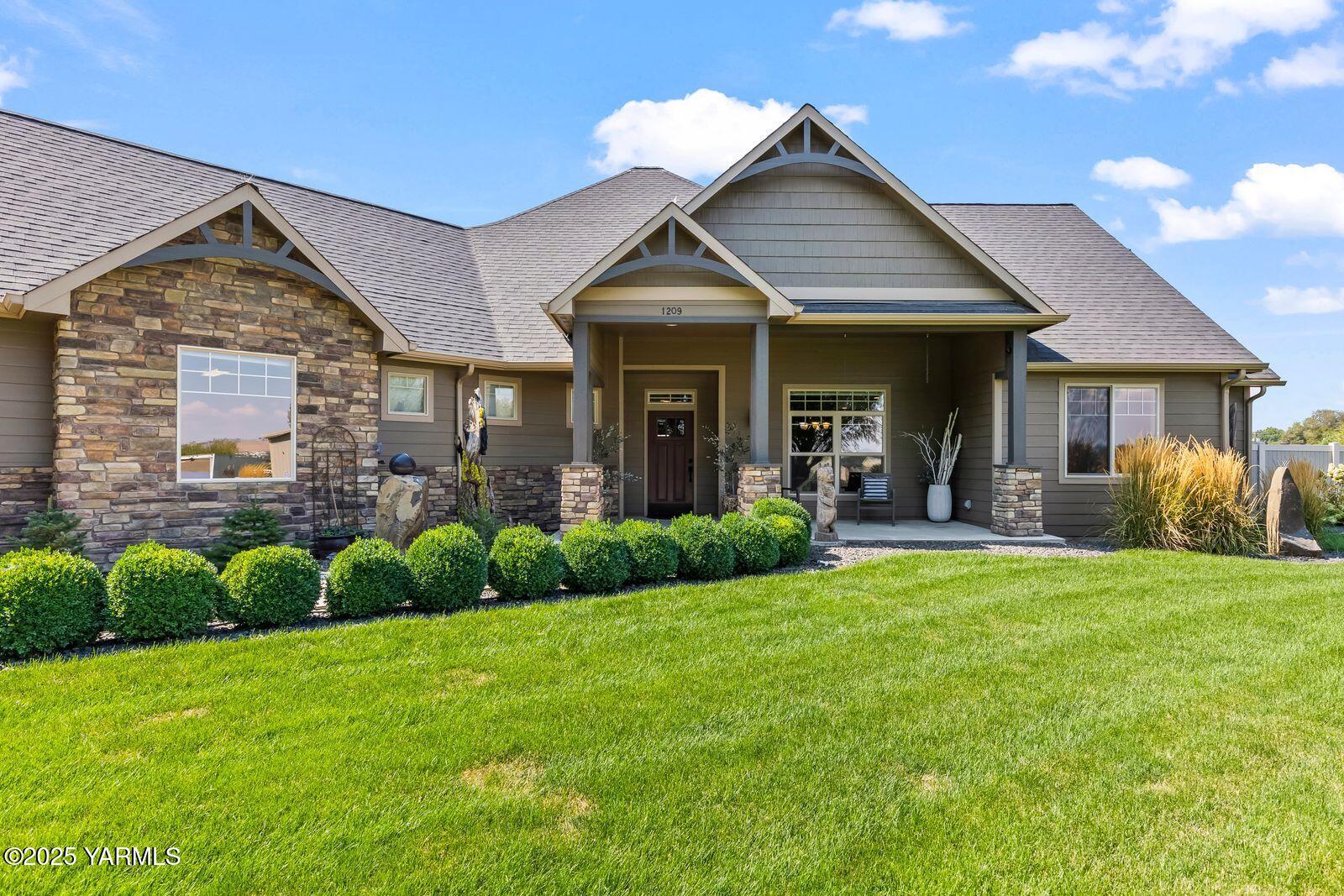 1209 Dazet Road Yakima, WA 98908 - Photo 38 of 63 a view of a house with a yard and lawn chairs with a fire pit