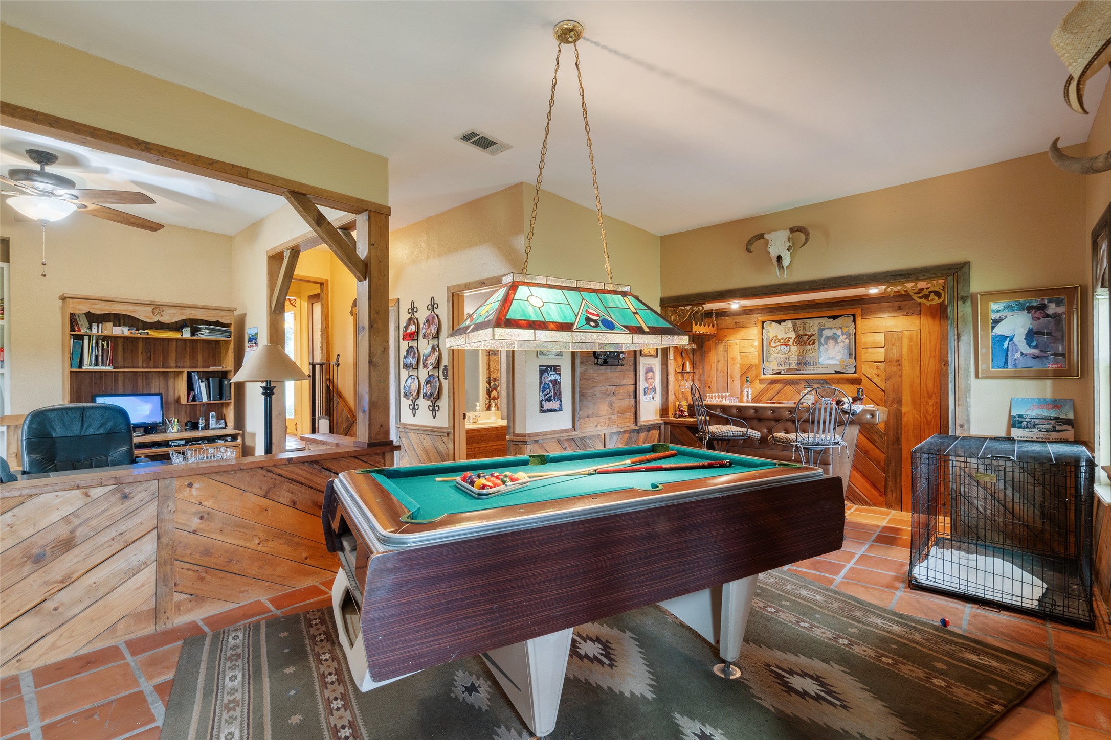 23200 Fulkes Road Leander, TX 78641 - Photo 4 of 15 A vibrant game room with an inviting bar and ample space for entertainment.