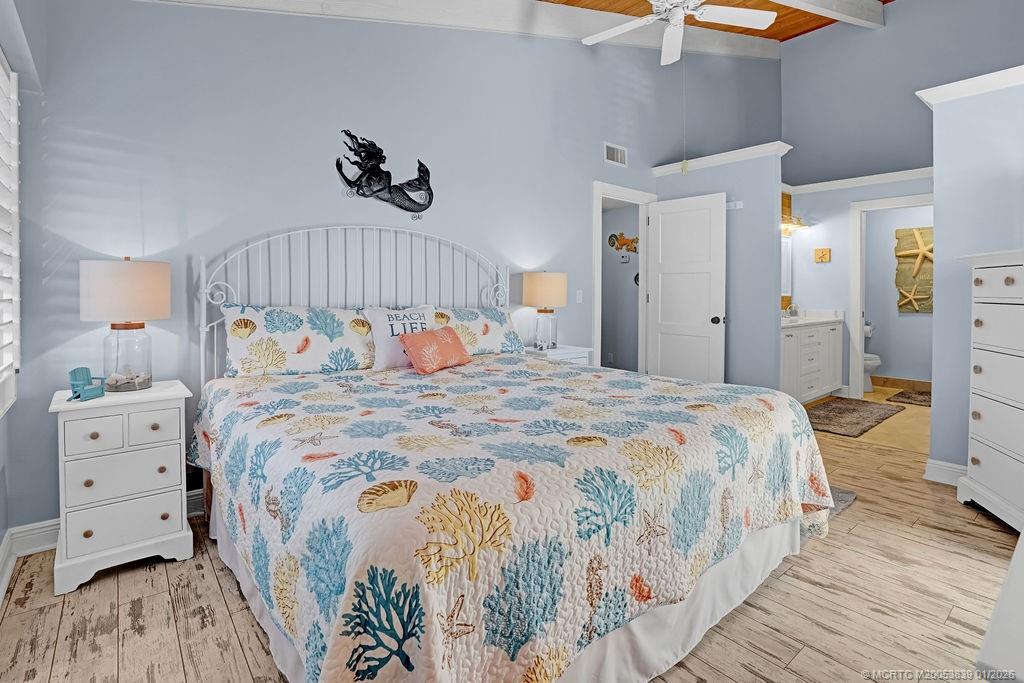 2355 Northeast Ocean Boulevard, Unit 39B Stuart, FL 34996 - Photo 13 of 22 a bedroom with a bed and a lamp on dresser