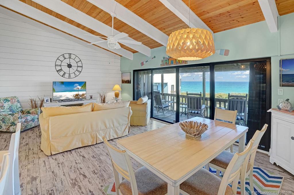 2355 Northeast Ocean Boulevard, Unit 39B Stuart, FL 34996 - Photo 3 of 22 a view of a dining room with furniture a chandelier and a rug