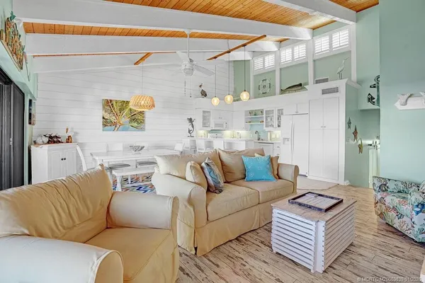 a living room with furniture and a painting on the wall