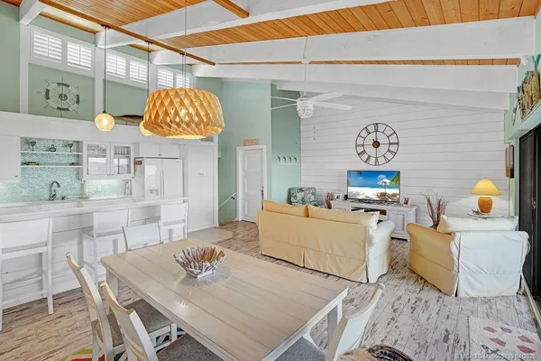 a living room with furniture and kitchen view