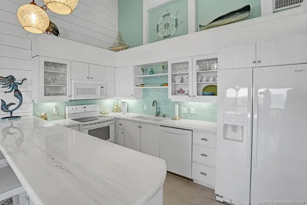 a kitchen with cabinets and window