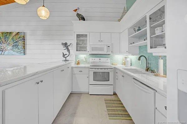 a kitchen with a sink cabinets and window