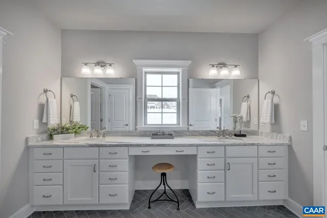 a spacious bathroom with a granite countertop sink mirror and