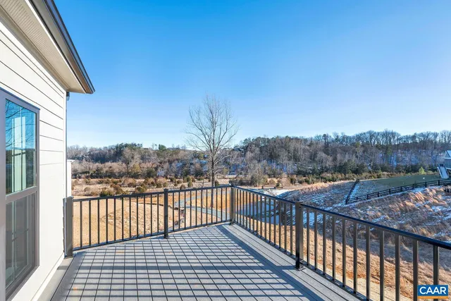 a view of a balcony with wooden fence and floor