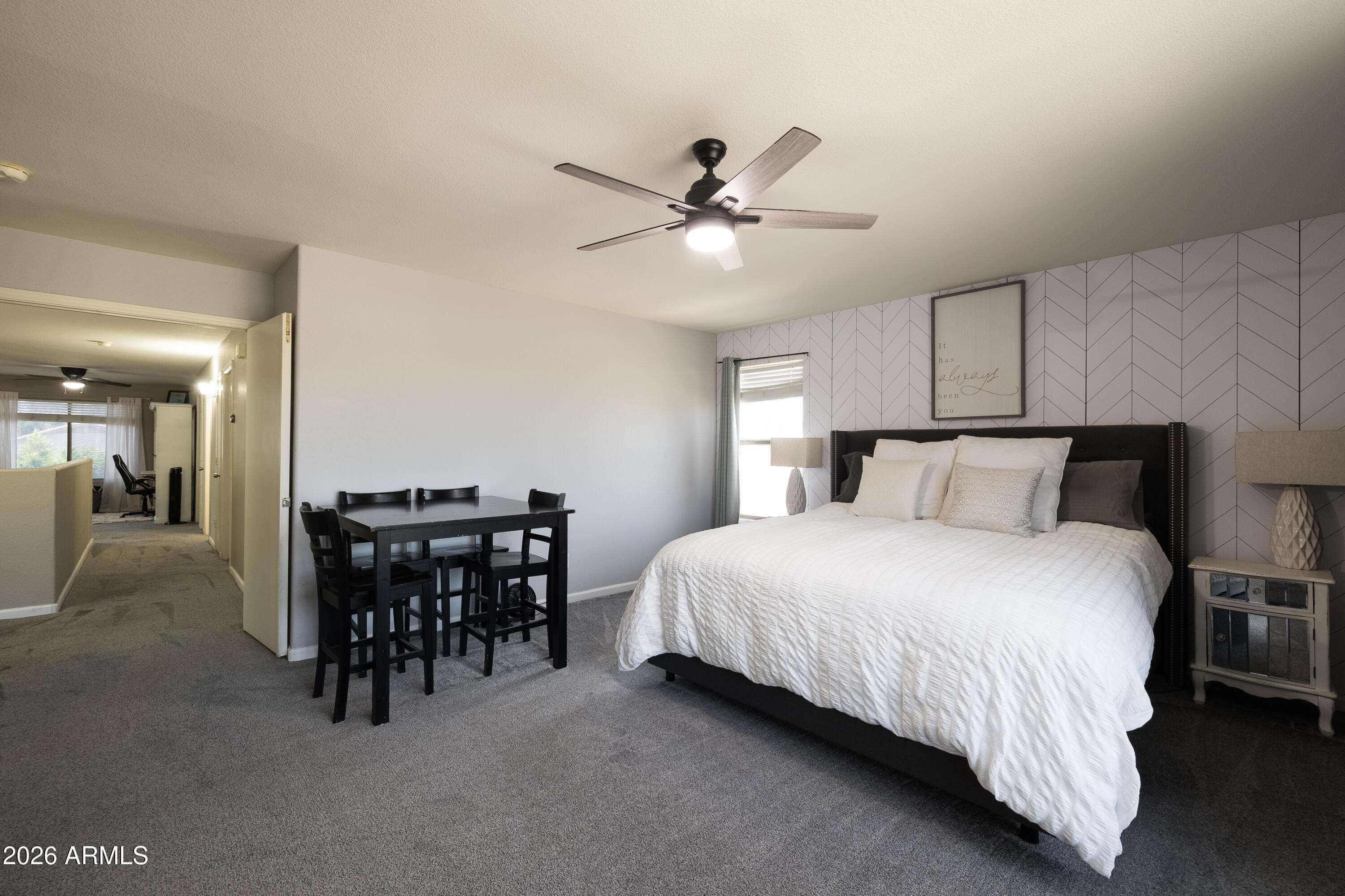 6407 West Saddlehorn Road Phoenix, AZ 85083 - Photo 35 of 41 a bedroom with a bed and a chandelier