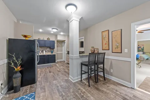 a view of a a dining room with furniture window and wooden floor