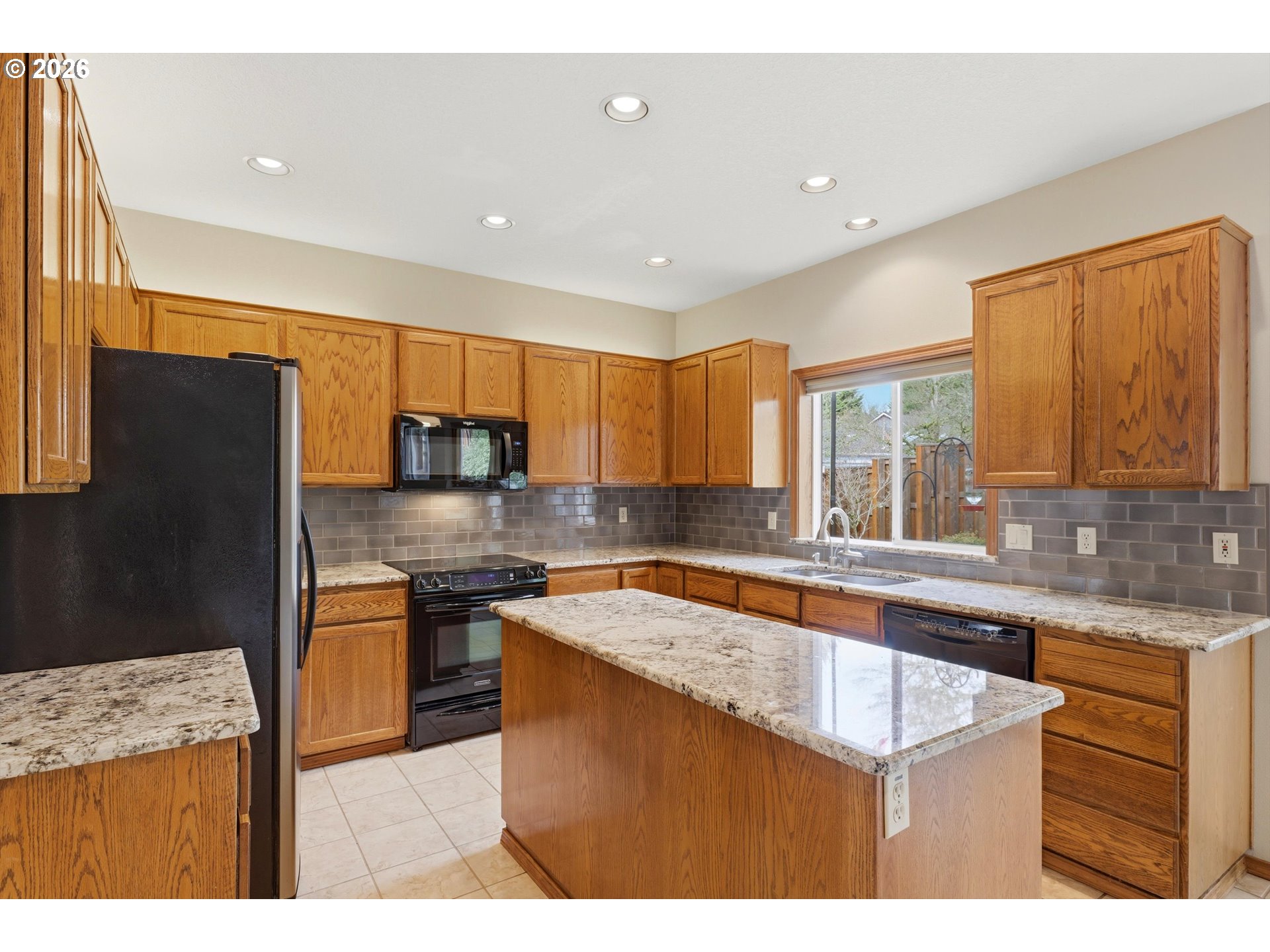 16943 Northwest Patrick Lane Portland, OR 97229 - Photo 16 of 45 a kitchen with stainless steel appliances granite countertop a sink a stove and refrigerator