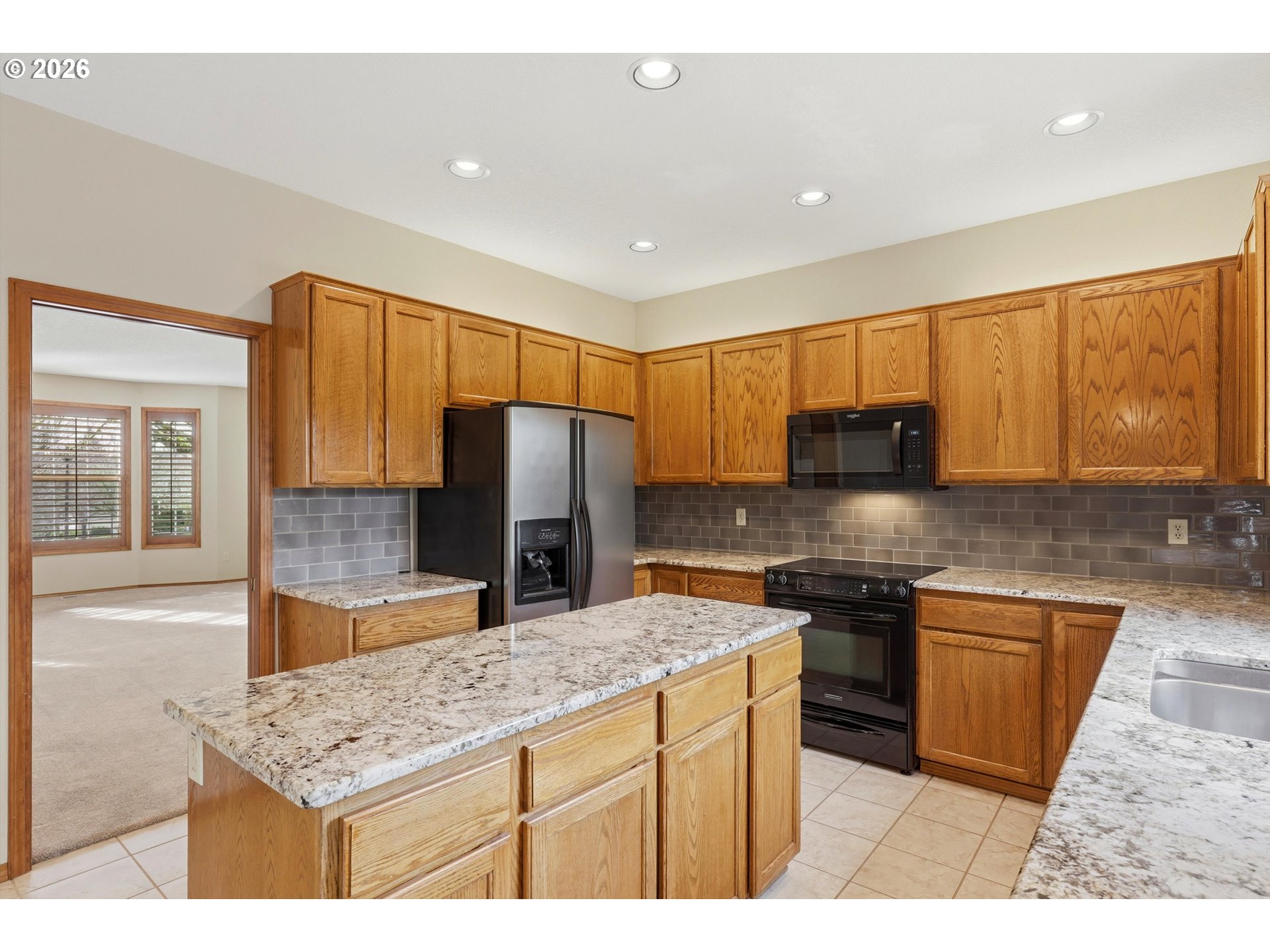 16943 Northwest Patrick Lane Portland, OR 97229 - Photo 17 of 45 a kitchen with stainless steel appliances granite countertop a sink stove and refrigerator