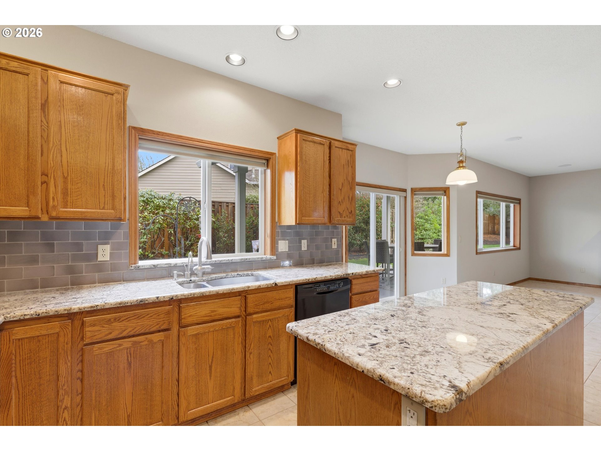 16943 Northwest Patrick Lane Portland, OR 97229 - Photo 18 of 45 a kitchen with granite countertop sink stove and cabinets