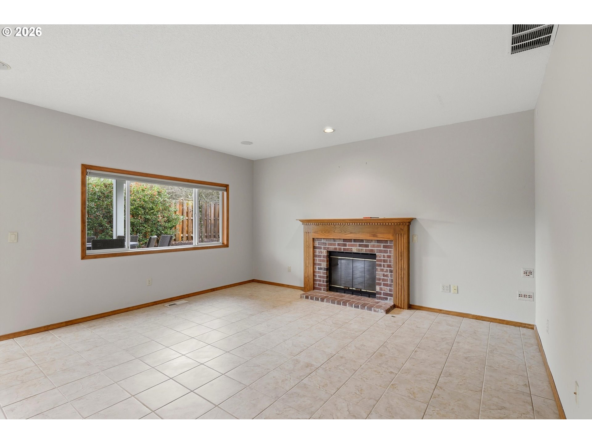 16943 Northwest Patrick Lane Portland, OR 97229 - Photo 20 of 45 a view of an empty room with a window and a fireplace