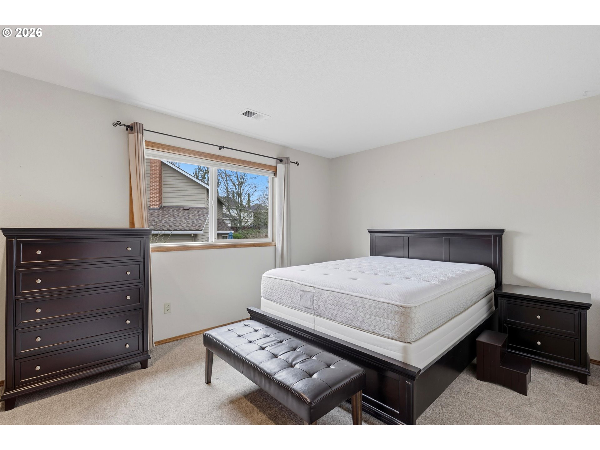 16943 Northwest Patrick Lane Portland, OR 97229 - Photo 31 of 45 a bedroom with a bed a dresser and a window