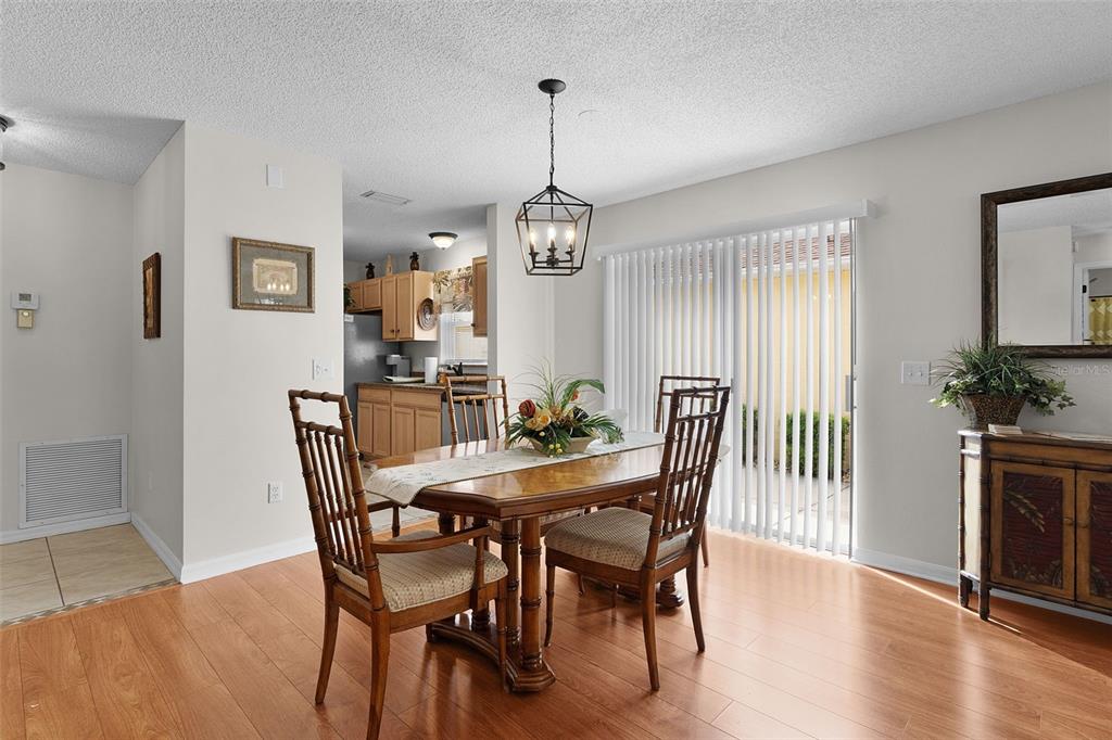 1116 San Bernardo Road The Villages, FL 32162 - Photo 14 of 46 a view of a dining room with furniture window and wooden floor