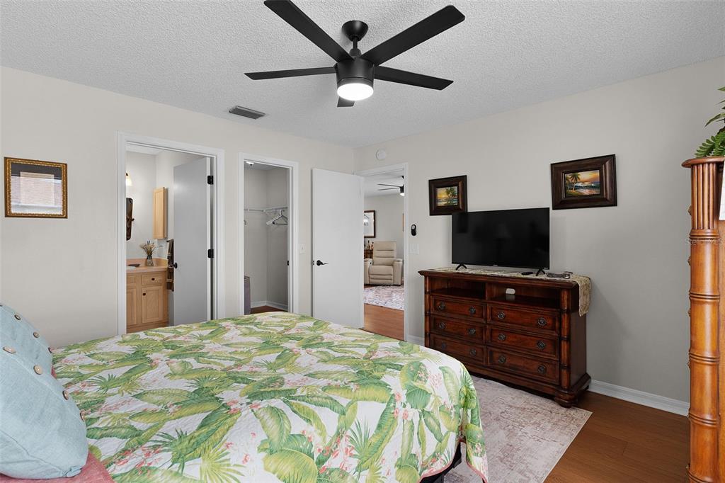 1116 San Bernardo Road The Villages, FL 32162 - Photo 21 of 46 a bedroom with a bed and a flat screen tv