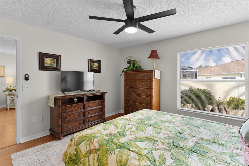 1116 San Bernardo Road The Villages, FL 32162 - Photo 22 of 46 a bedroom with a bed and a flat screen tv