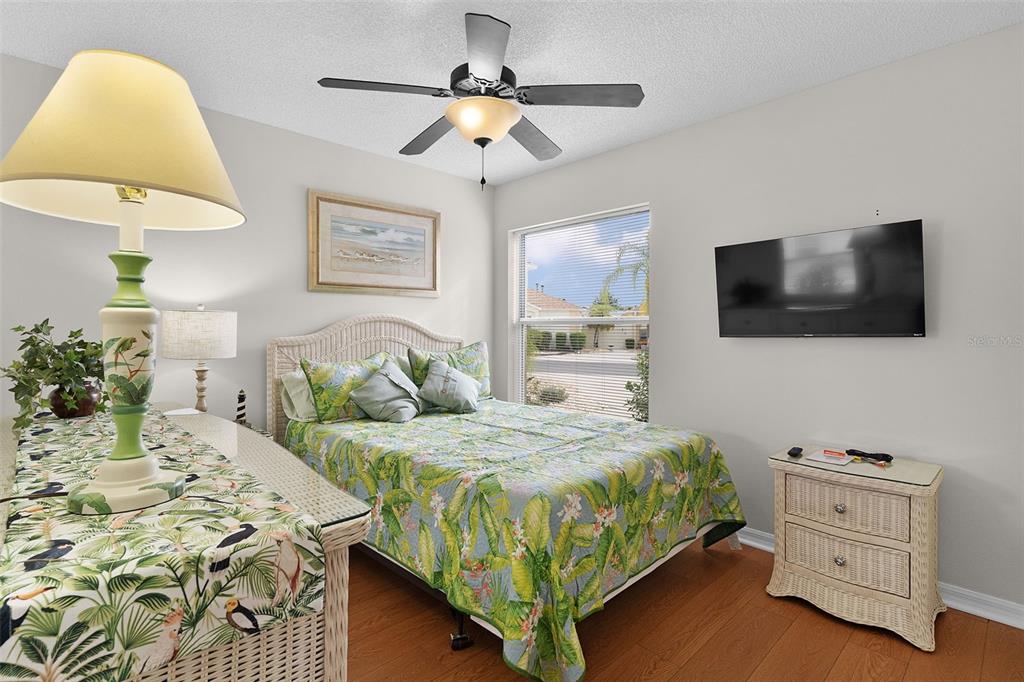 1116 San Bernardo Road The Villages, FL 32162 - Photo 25 of 46 a bedroom with a bed and a flat screen tv