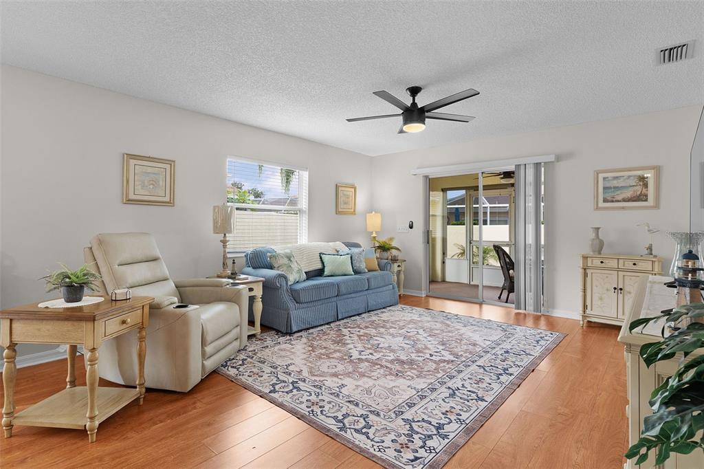 1116 San Bernardo Road The Villages, FL 32162 - Photo 7 of 46 a living room with furniture and a rug