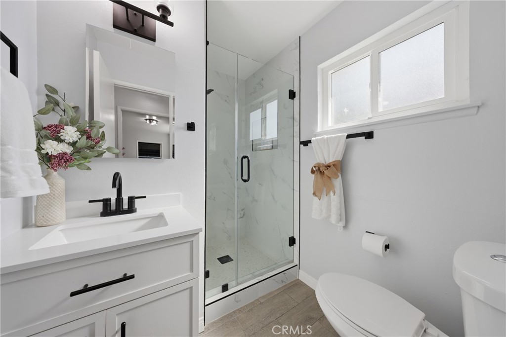 5653 Corwin Lane Riverside, CA 92503 - Photo 8 of 14 a bathroom with a sink a toilet and shower