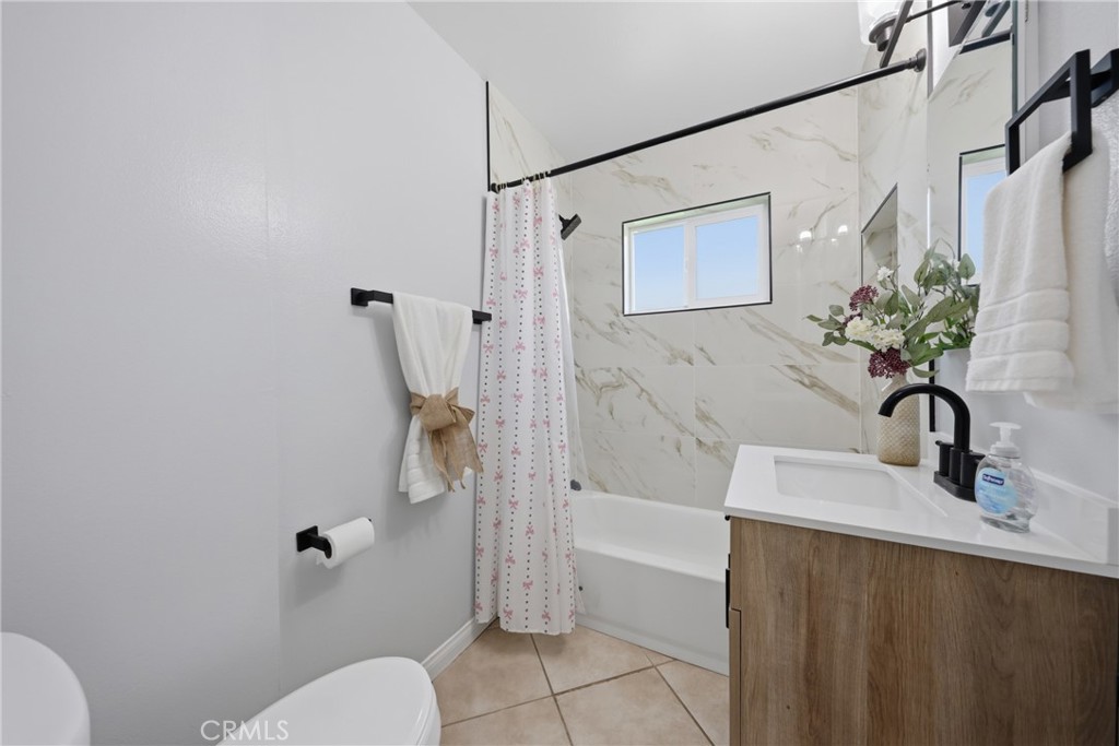 5653 Corwin Lane Riverside, CA 92503 - Photo 10 of 14 a bathroom with a sink a toilet and shower