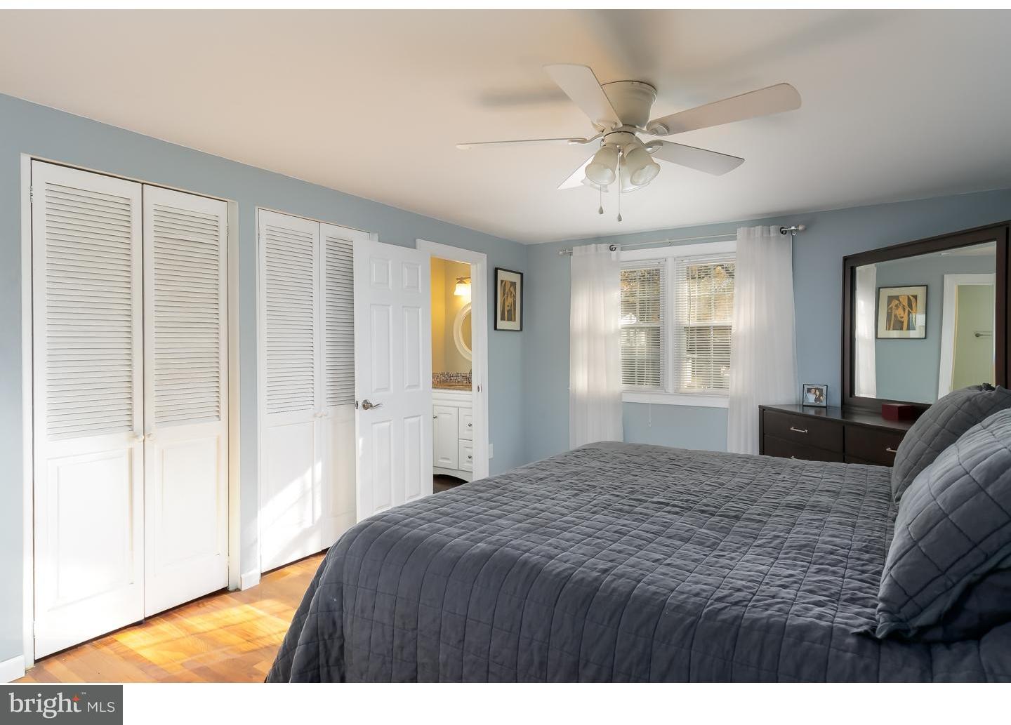 13 Ridgewood Avenue Delran, NJ 08075 - Photo 16 of 25 a bedroom with a large bed and a chandelier