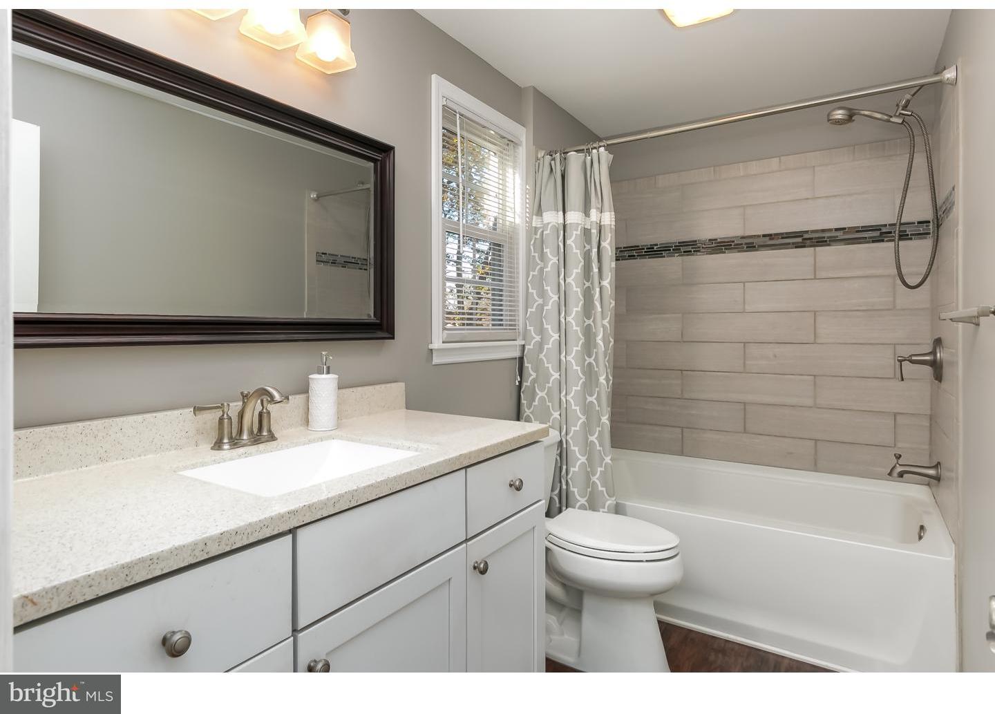 13 Ridgewood Avenue Delran, NJ 08075 - Photo 21 of 25 a bathroom with a bathtub shower sink vanity mirror and toilet