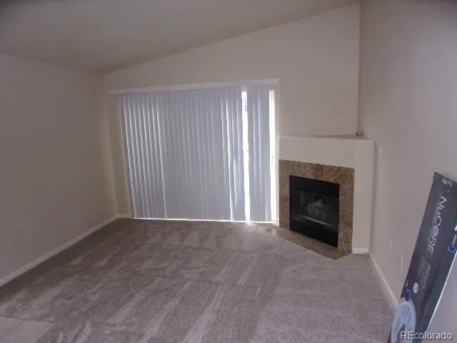 a view of empty room with a fireplace