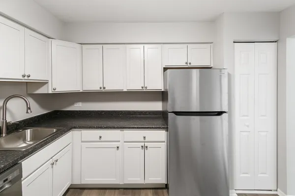 a white refrigerator freezer sitting inside of a kitchen