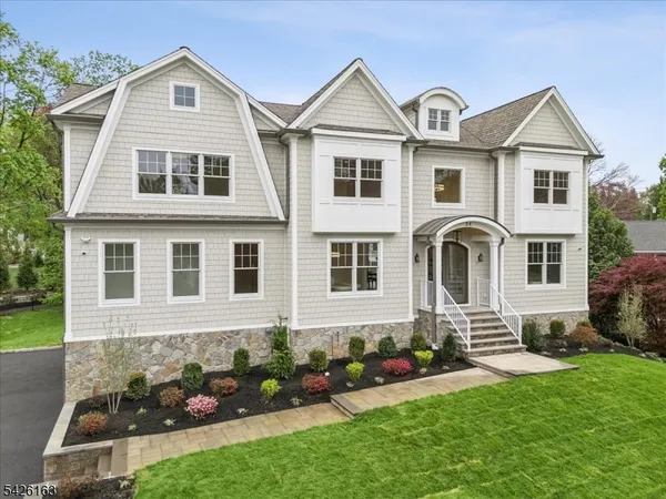 a front view of a house with a garden