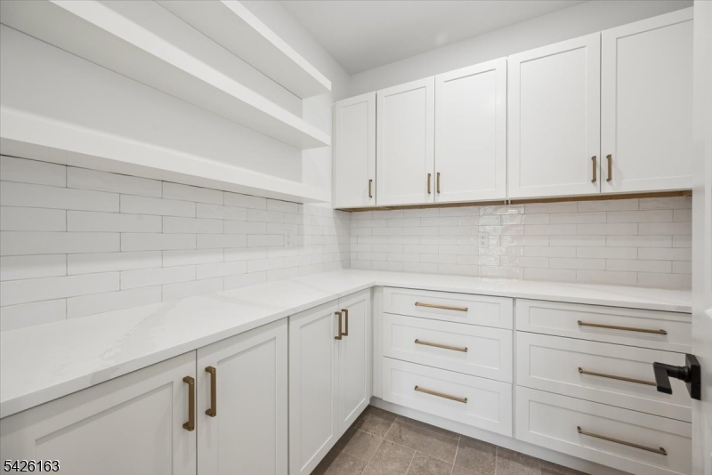 34 Crestview Avenue Madison, NJ 07940 - Photo 18 of 43 a kitchen with white cabinets and a white stove