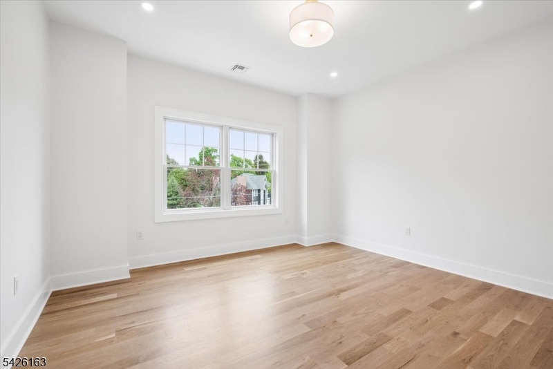 34 Crestview Avenue Madison, NJ 07940 - Photo 27 of 43 an empty room with wooden floor and windows