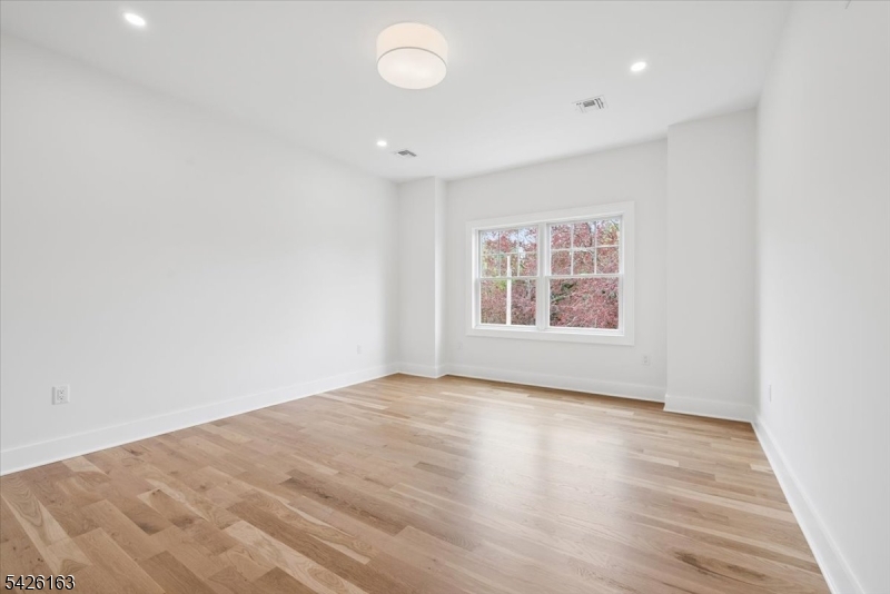 34 Crestview Avenue Madison, NJ 07940 - Photo 29 of 43 an empty room with wooden floor and windows