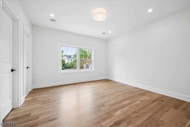 34 Crestview Avenue Madison, NJ 07940 - Photo 31 of 43 an empty room with wooden floor and windows