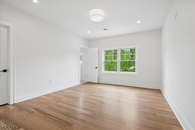 34 Crestview Avenue Madison, NJ 07940 - Photo 33 of 43 an empty room with wooden floor and windows