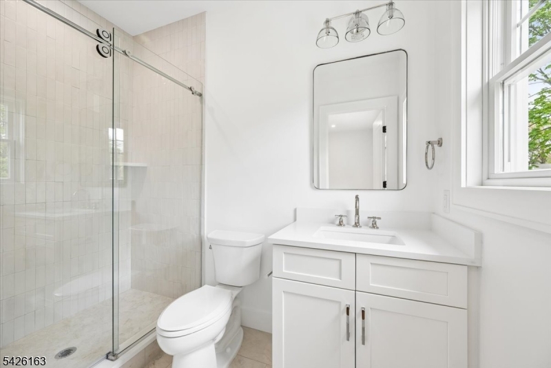 34 Crestview Avenue Madison, NJ 07940 - Photo 34 of 43 a bathroom with a sink toilet vanity and shower