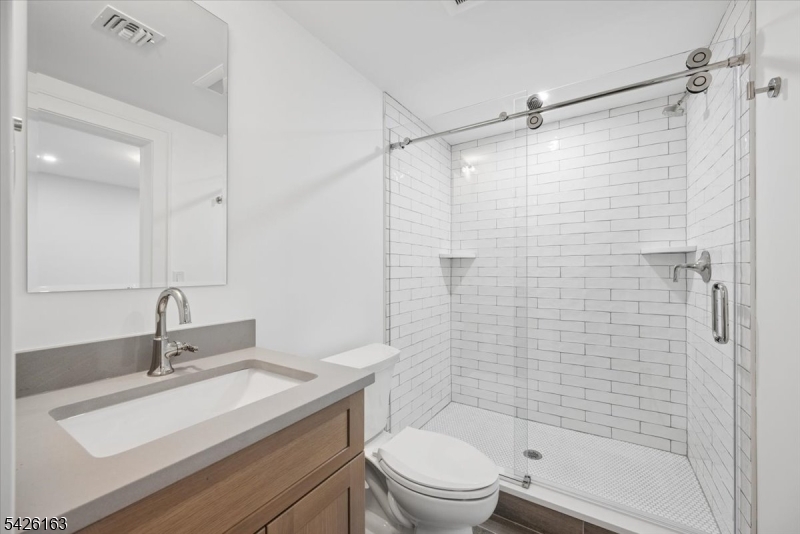 34 Crestview Avenue Madison, NJ 07940 - Photo 36 of 43 a bathroom with a sink toilet vanity and shower