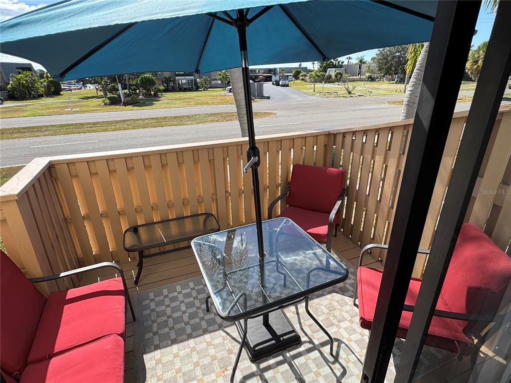 6504 Abaco Drive, Unit 101 Apollo Beach, FL 33572 - Photo 33 of 34 a view of balcony with furniture and umbrella